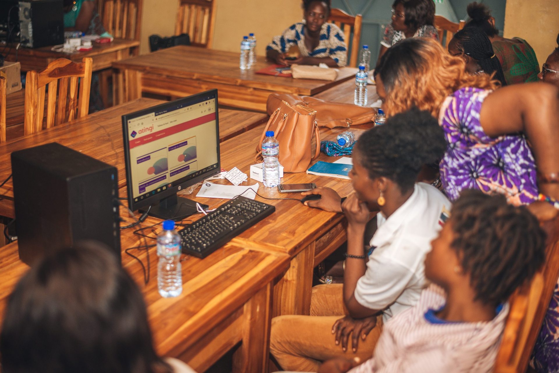 Women taking an atingi course on a desktop computer