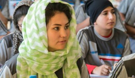 Four young women wearing hijab in a class room setting