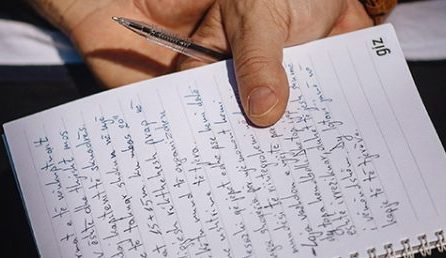 Close up of a notepad with writing on it